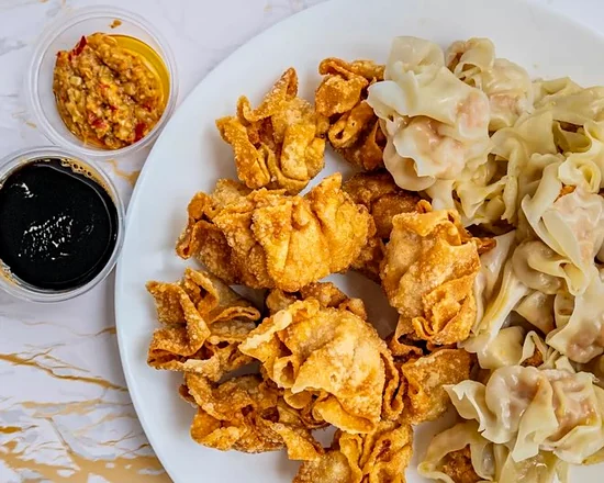 Plate of half fried and half steamed pork siomai with chili garlic and soylime